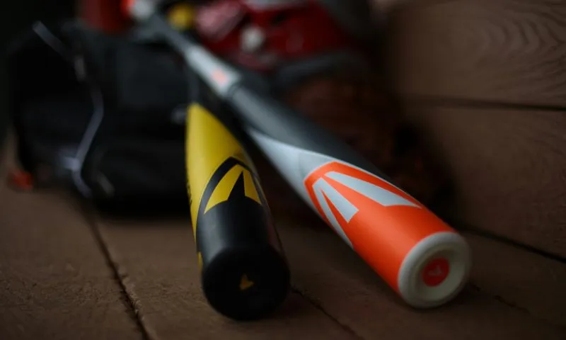 Two baseball bats resting on a bench, representing the focus of a case study on mobile app design for a baseball company.