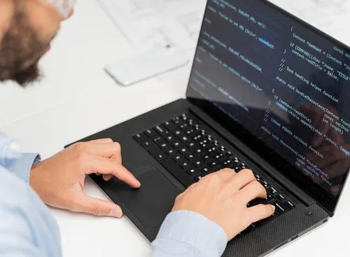 A man typing on a laptop, representing quick and effective accessibility solutions for websites.
