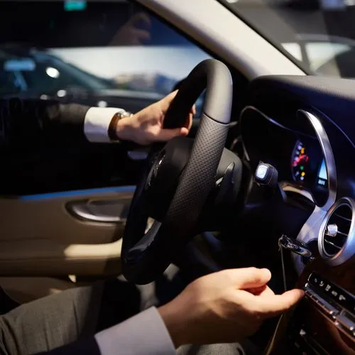 A man in a suit drives a car, showcasing WhizzBridge's AI solution for enhanced driver safety and real-time monitoring.