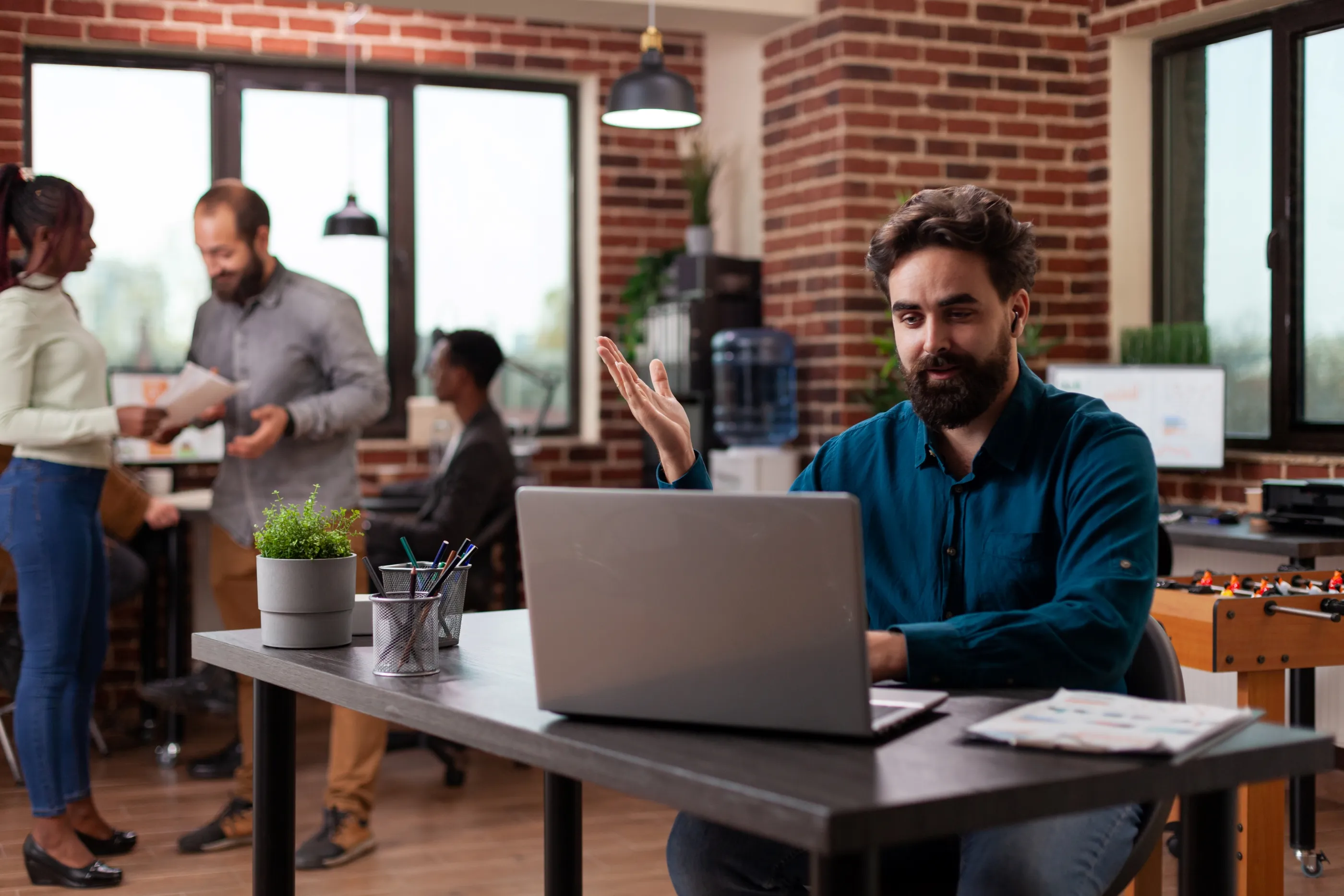 A man sits at a desk with a laptop, focused on streamlining operations using a custom Salesforce CRM.