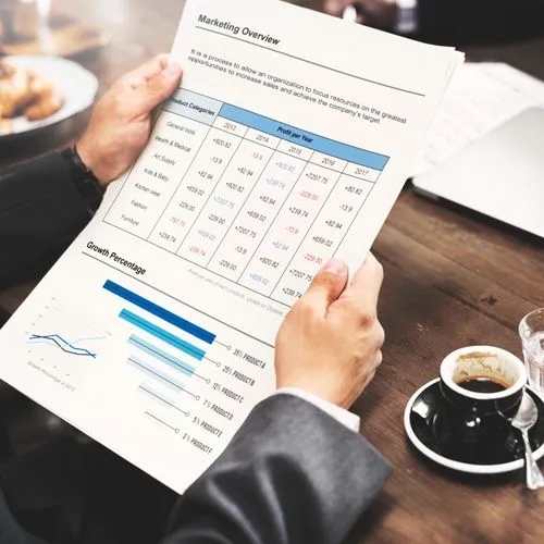 Businessman holding a financial report, representing efficient time tracking and project management in a cloud-based application.
