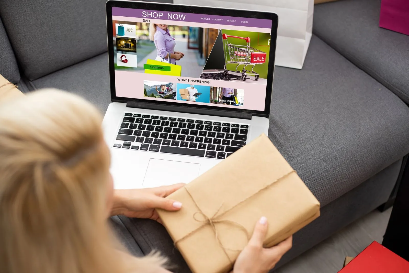 A woman holds a laptop displaying a box, symbolizing e-commerce performance enhancement through localization and UX improvements.