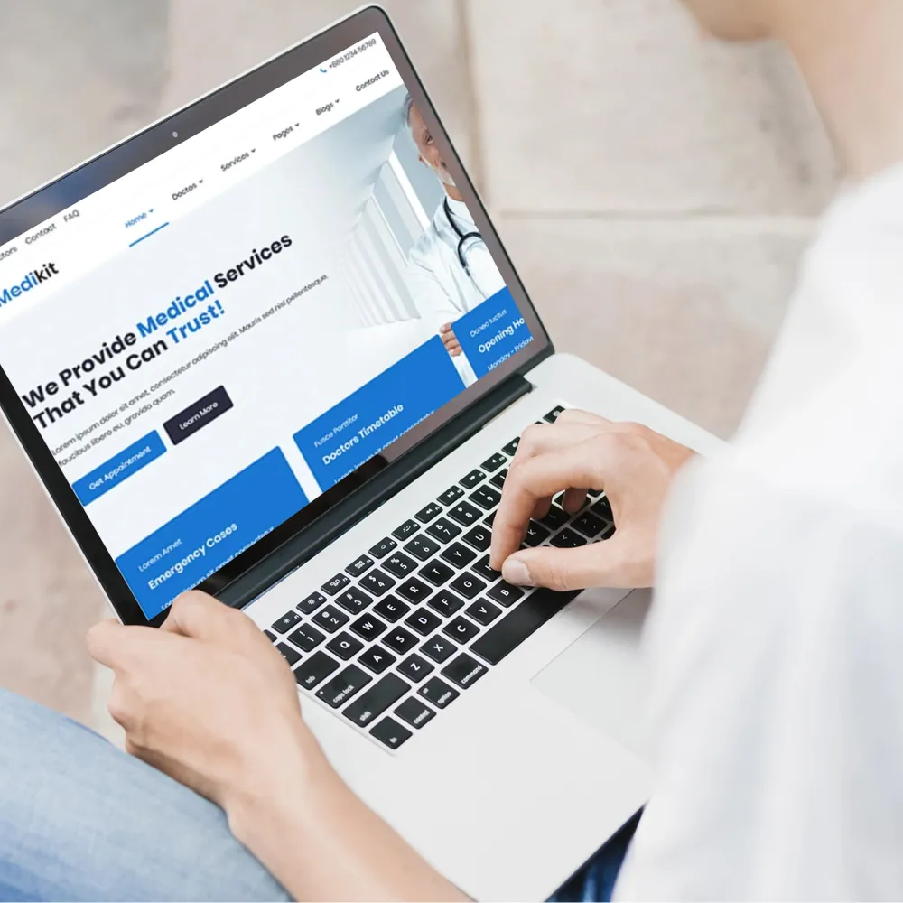  A person using a laptop displaying the word "healthcare," highlighting a secure web application for patient management.