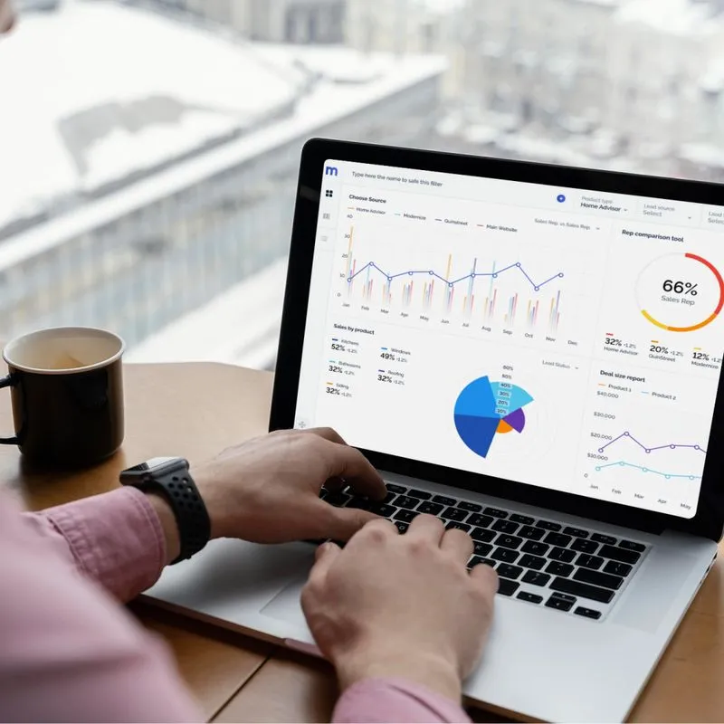 A person using a laptop displays a graph on the screen, illustrating data analysis for an AI-driven content creation platform.
