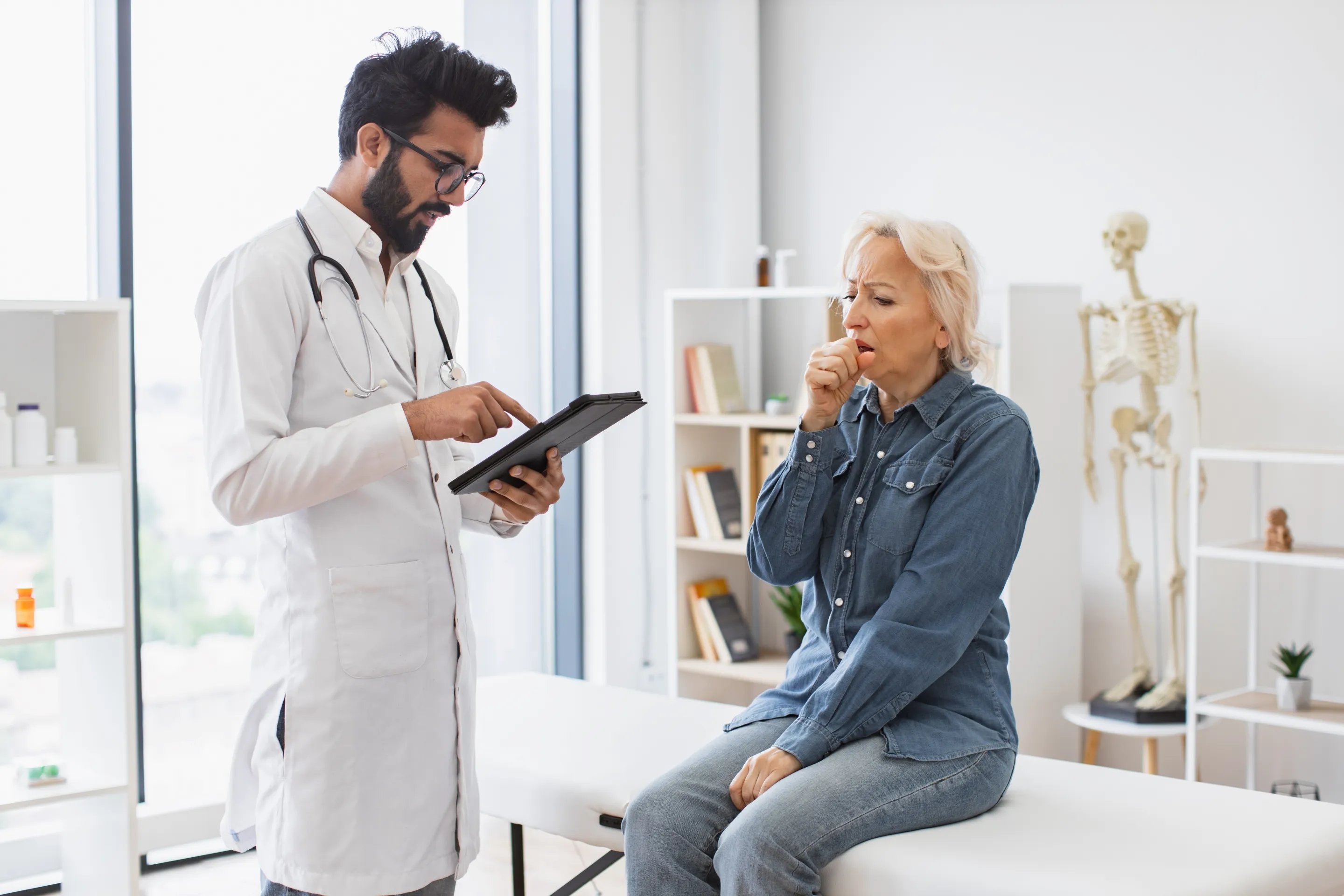 A doctor discusses hormone pellet therapy with a woman in a clinical setting, highlighting patient care.