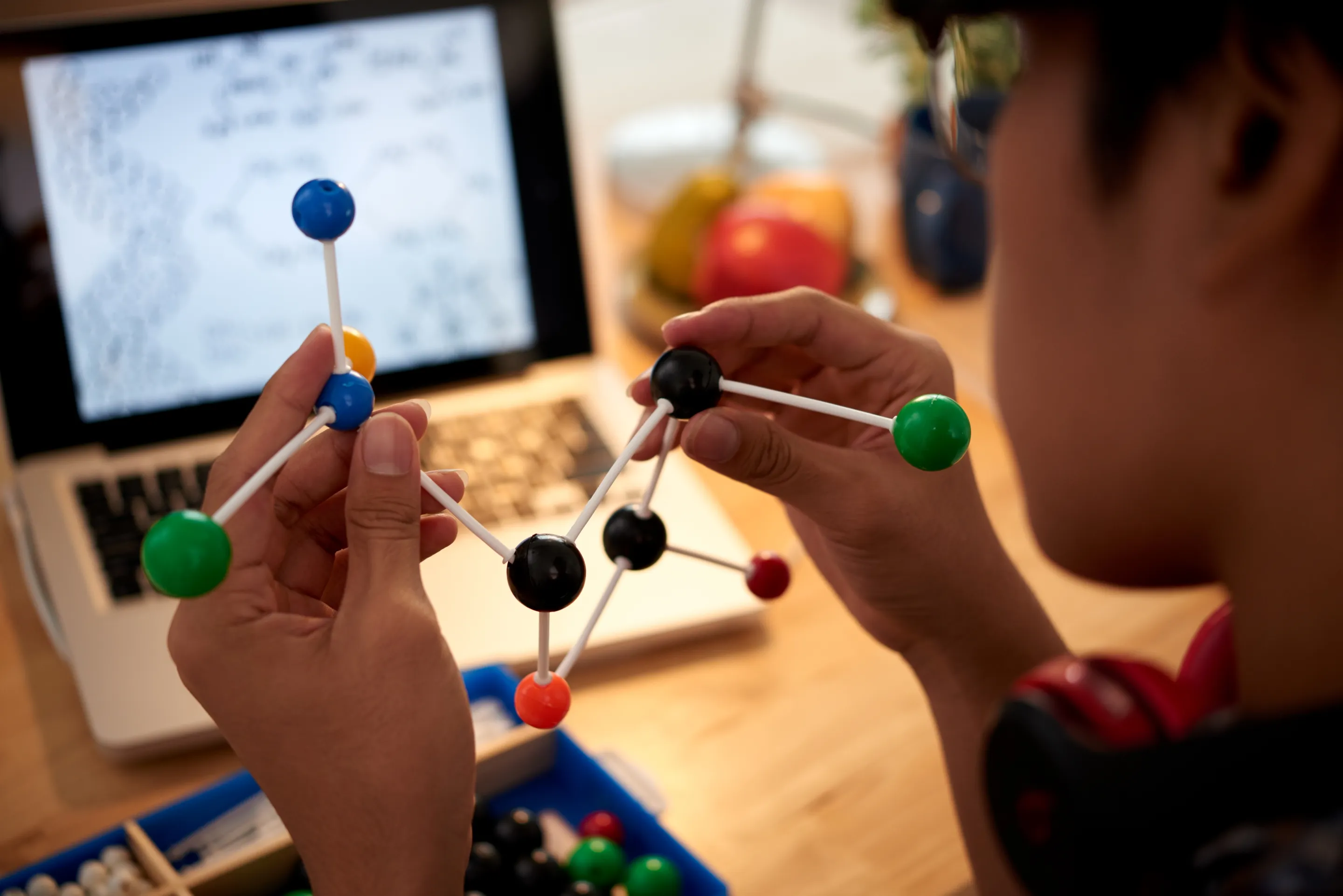A person constructs a molecular model, showcasing innovative educational technology in action.