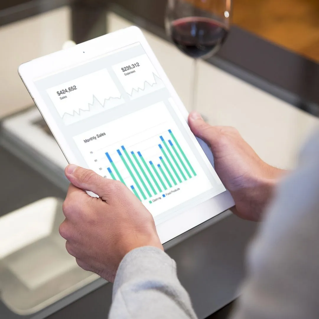 A person using a tablet displays a graph, illustrating the transition to a secure digital health record system.