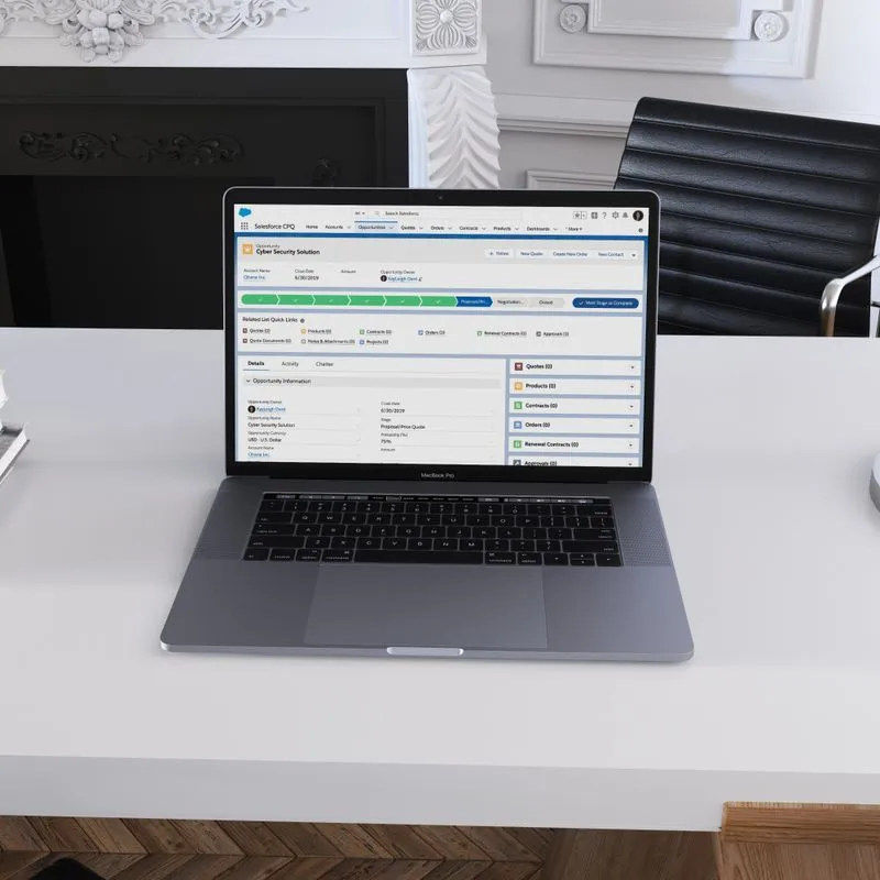 A laptop on a desk next to a steaming cup of coffee, symbolizing productivity and modern work environments.