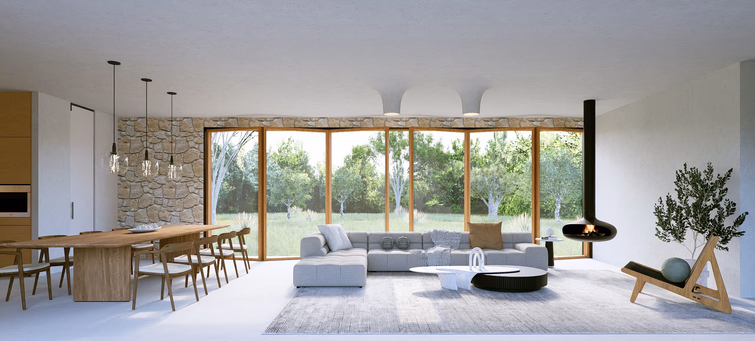 Villa Picasso I open plan living space with stone walls and suspended fireplace in Mougins