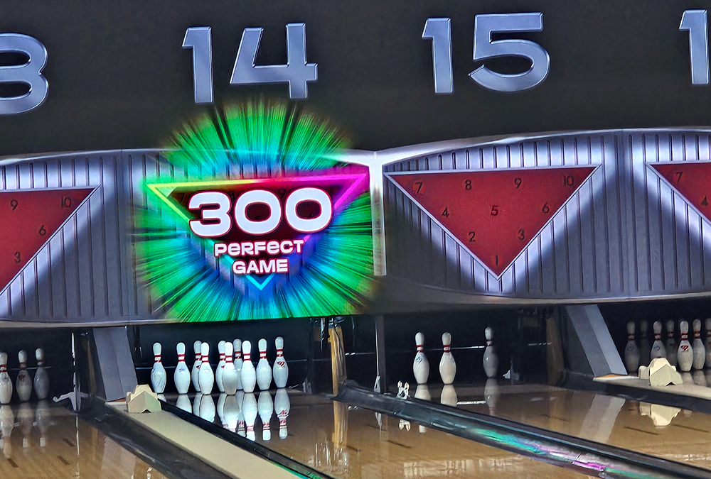 Bowling lanes showing a 300 perfect game neon sign above pins on lane 14.