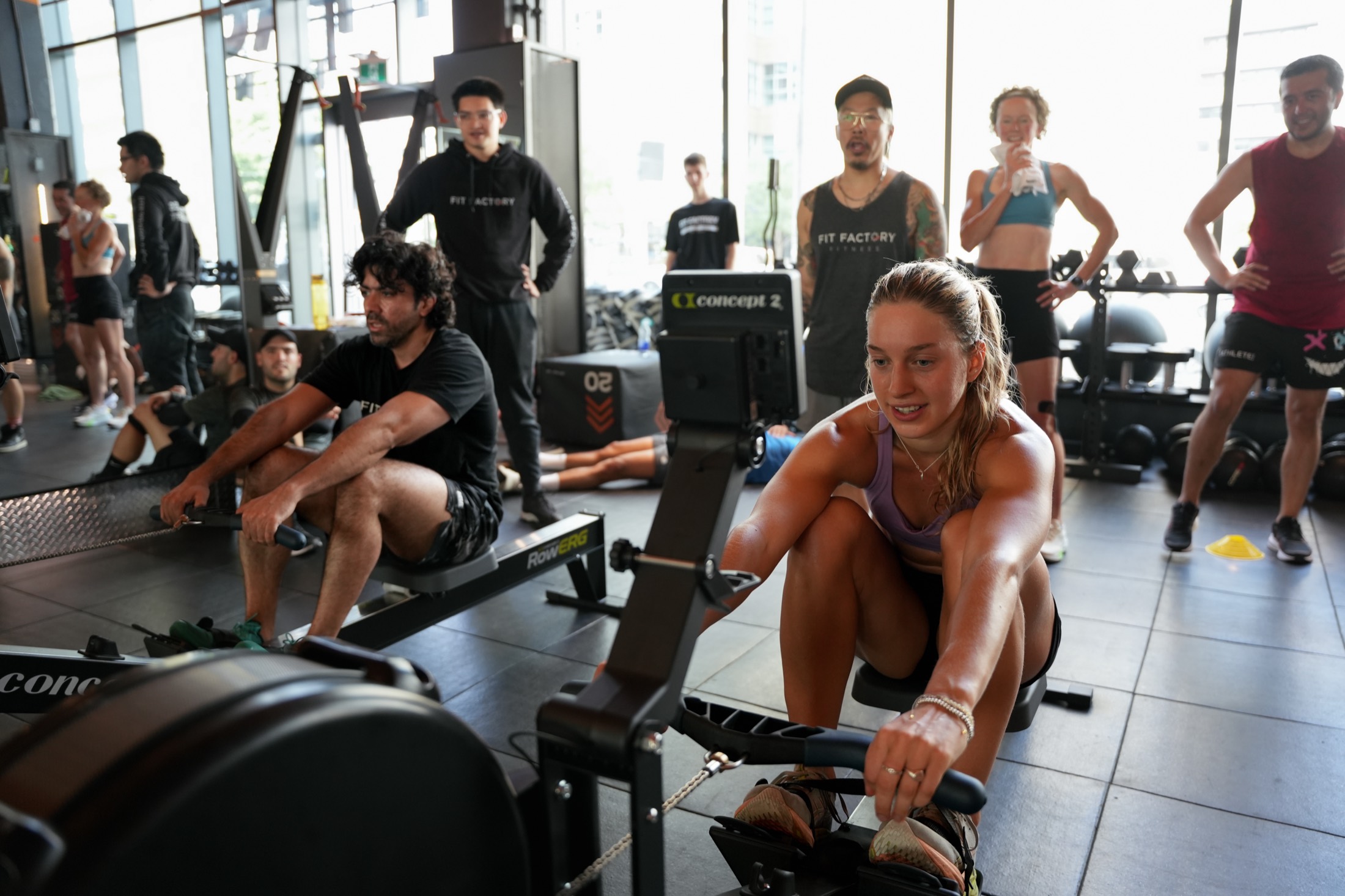 Members cheering each other on during a coached rowing class