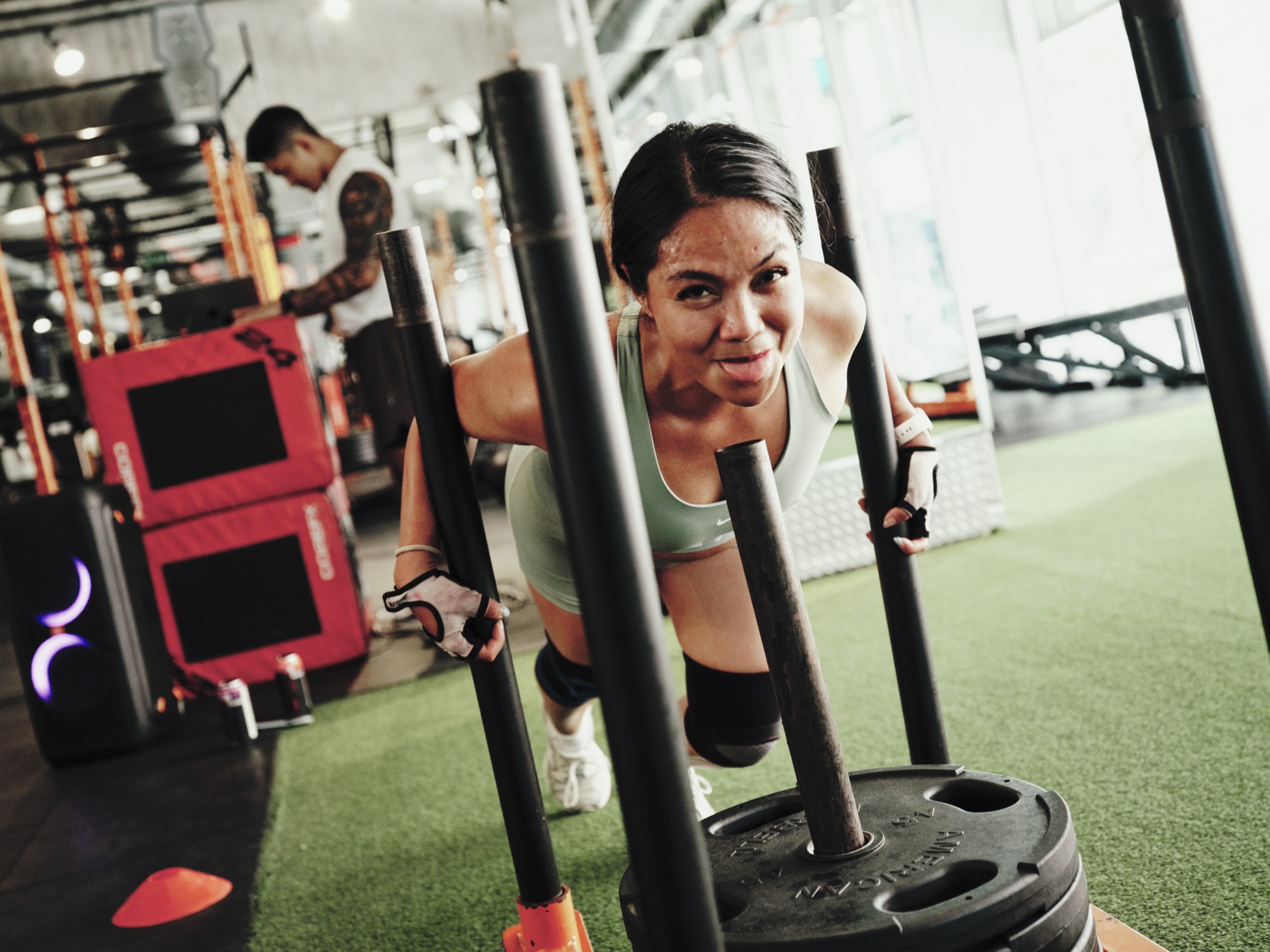 A member pushing a weighted sled during HYROX training in Toronto