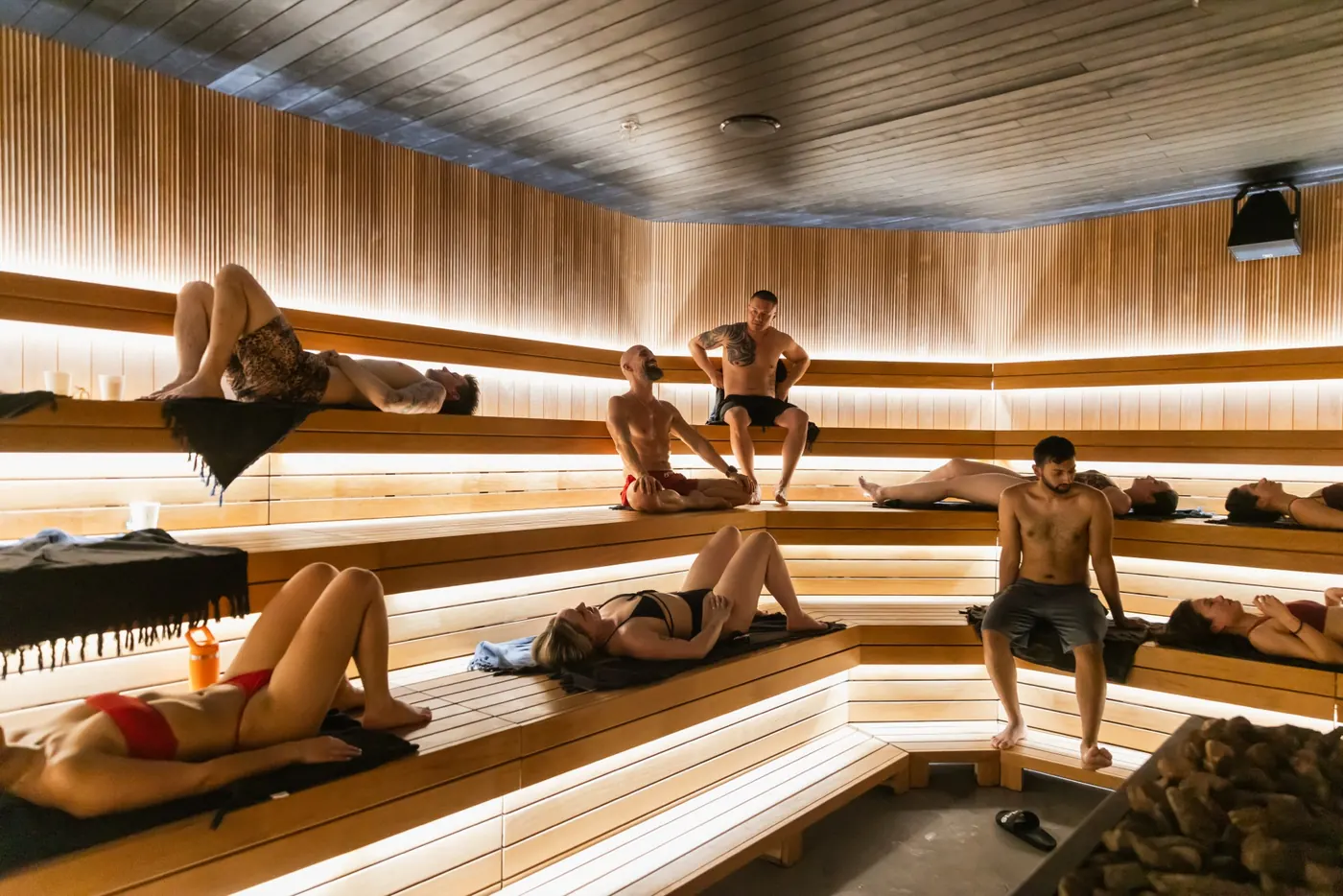 Guests relaxing together in the 60-person sauna at NRG Haus in Liberty Village, Toronto