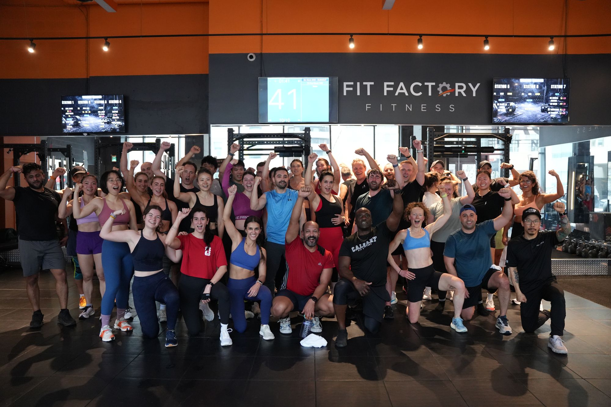 A Fit Factory Midtown class celebrates together after a workout