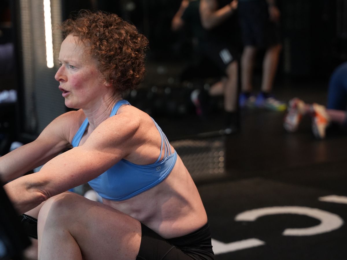 A member rows hard during a conditioning class at Fit Factory Midtown