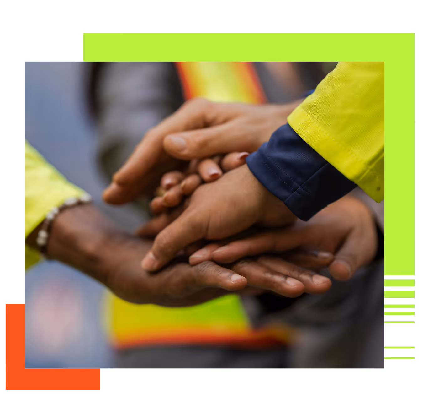 Close-up of several hands stacked together, symbolizing teamwork and unity.