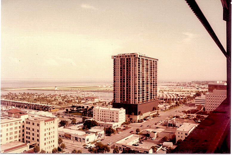 View of downtown St. Petersburg, Florida in the 1980s with a tall building near the waterfront and surrounding low-rise buildings.