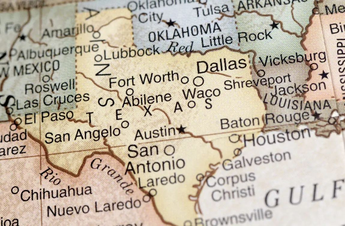 A close-up of a vintage-style map highlighting Texas cities like Dallas, Houston, Austin, San Antonio, and El Paso.