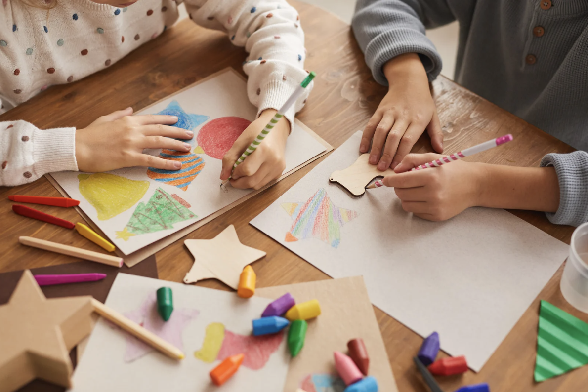 Kids drawing colorful designs for a bubble tea cup contest