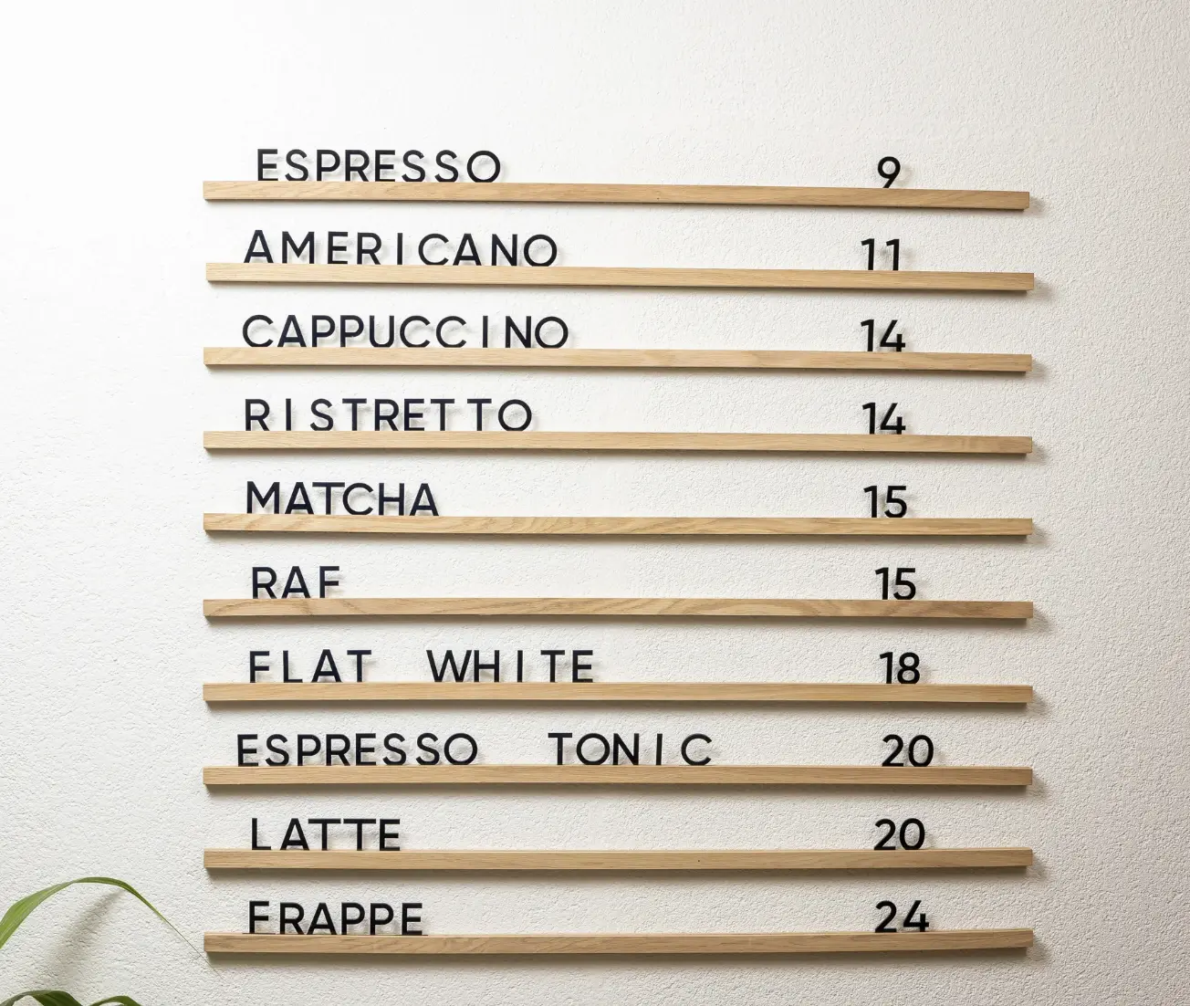 A modern coffee shop menu with wooden slats displaying coffee options and prices in a minimalist design.