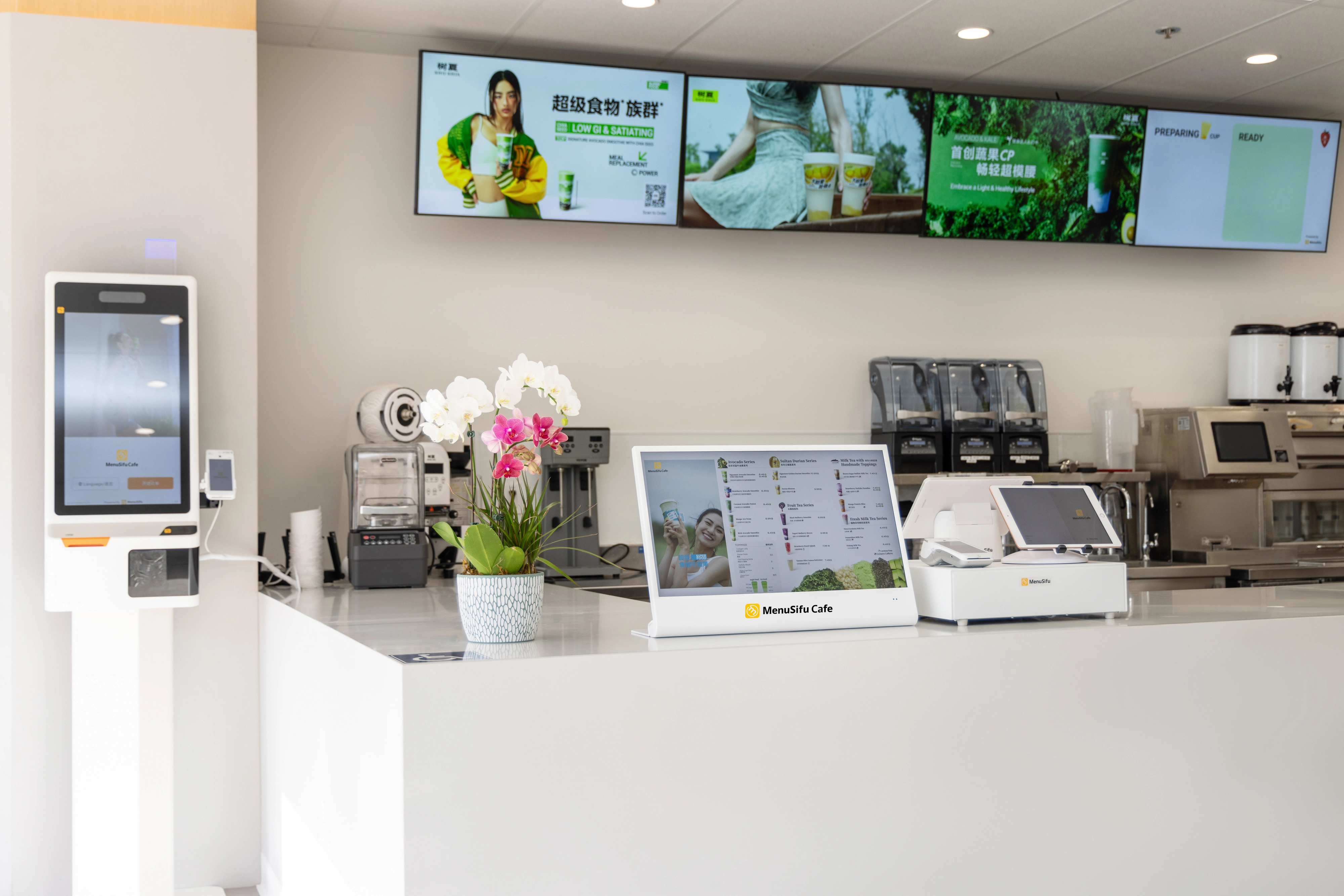 MenuSifu counter with self-service ordering kiosk, touchscreen POS, and digital signage in a modern café setup