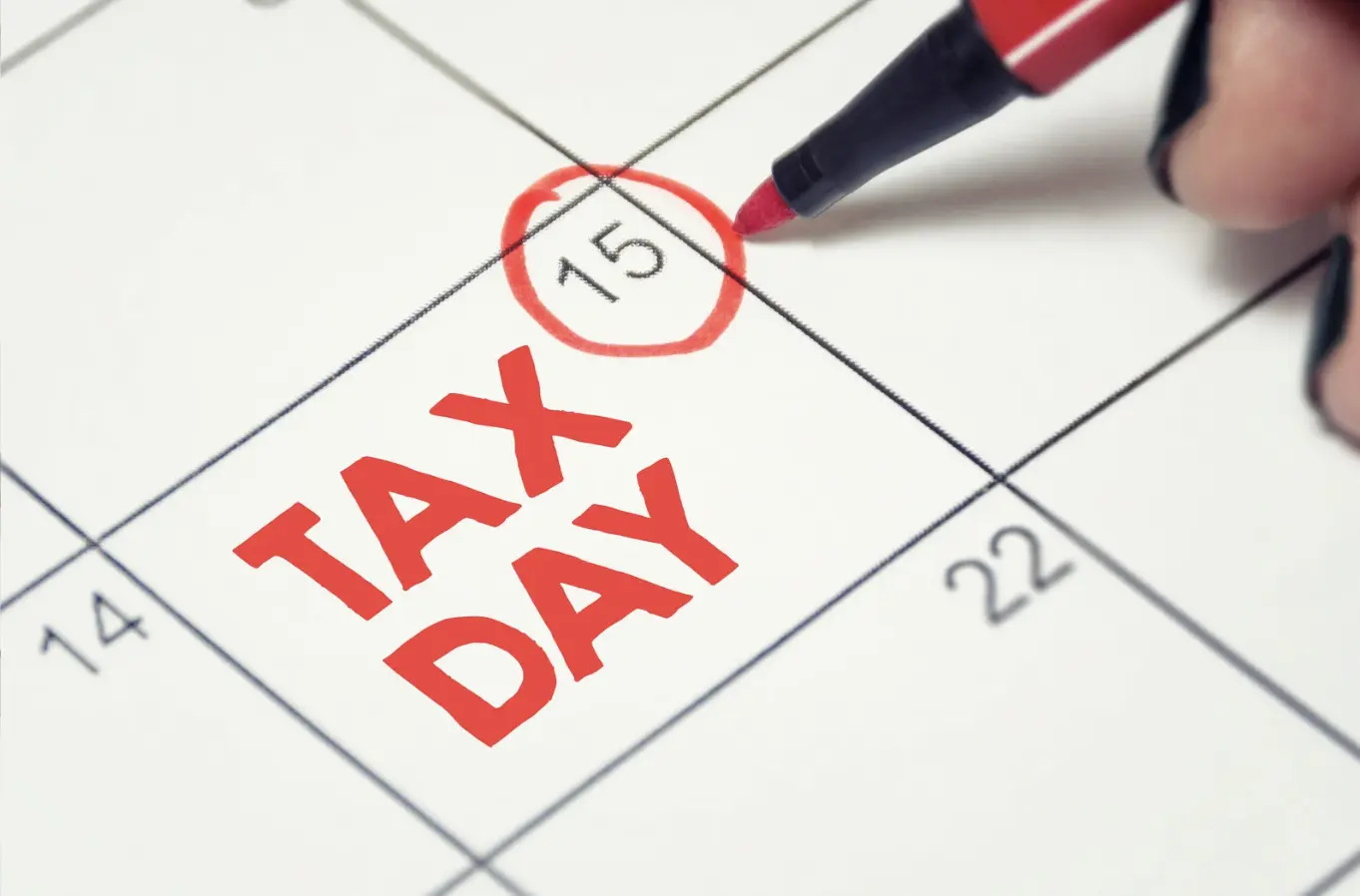 "A close-up of a calendar with April 15 circled in red, marking Tax Day."