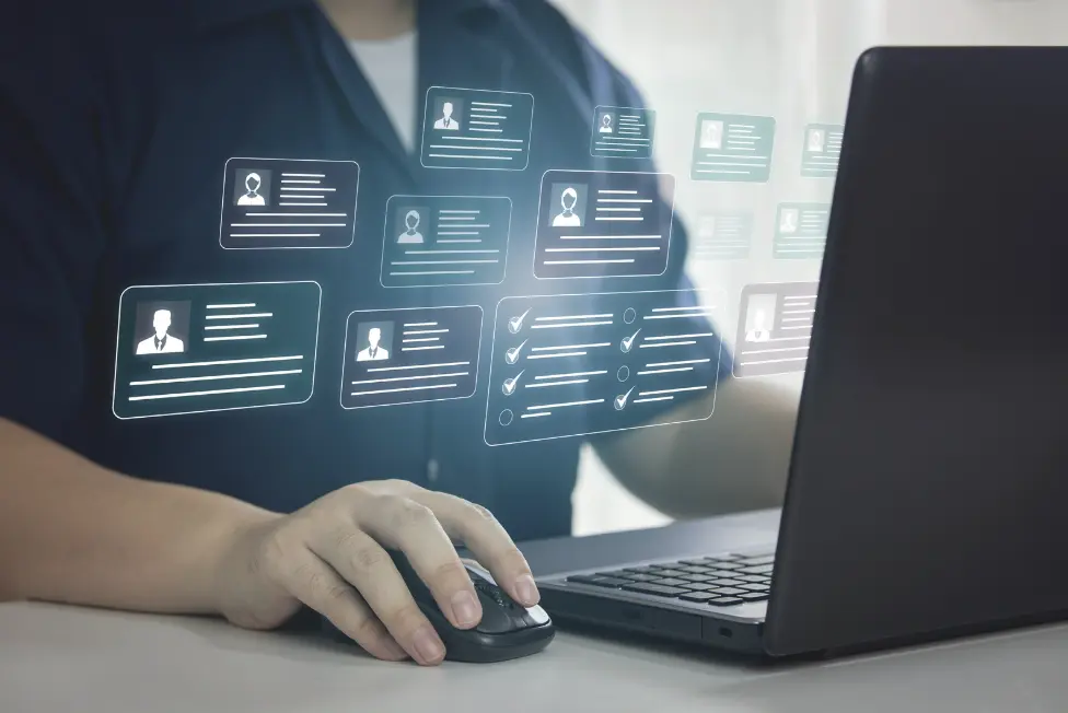 A person using a laptop with AI-powered digital customer profile management system, streamlining restaurant operations.