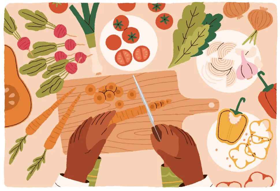 A pair of hands slicing carrots on a wooden cutting board, surrounded by various fresh vegetables like tomatoes, onions, and peppers.