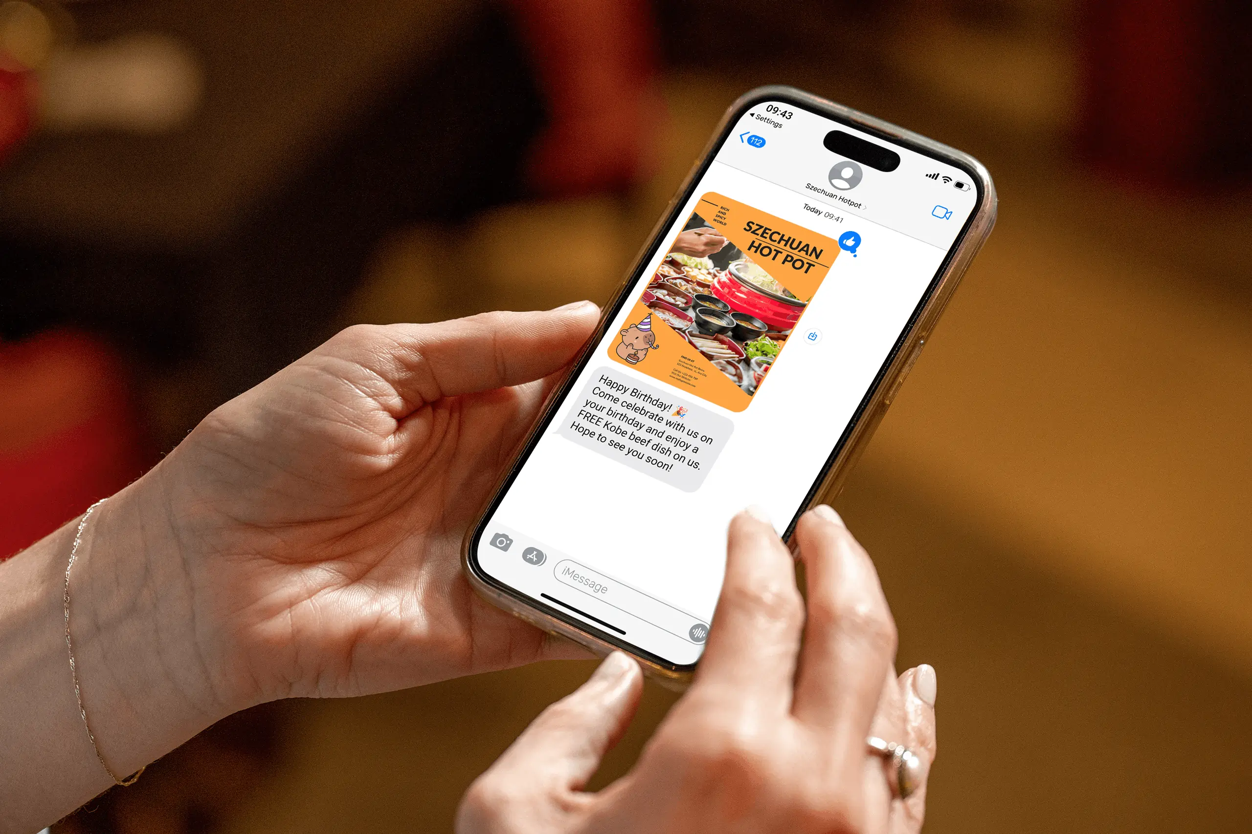A guest views birthday promo SMS offering coupons for restaurants from Szechuan Hot Pot for a free Kobe beef dish.