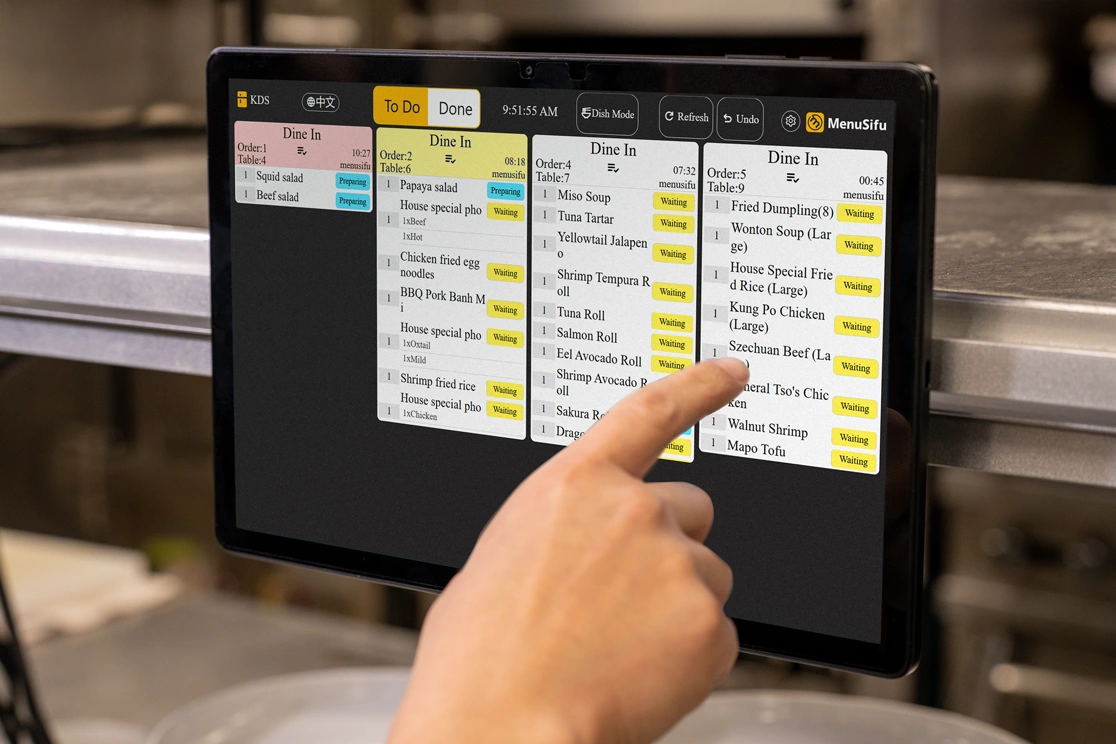 Touchscreen KDS shows queued Japanese tempura dishes by count and prep time, helping kitchen staff manage incoming orders fast.