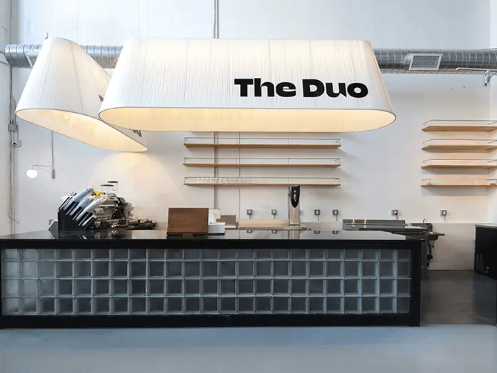 Minimalist counter setup at The Duo Coffee Shop and Bar, featured in bakery cafe POS system testimonial with sleek modern design.