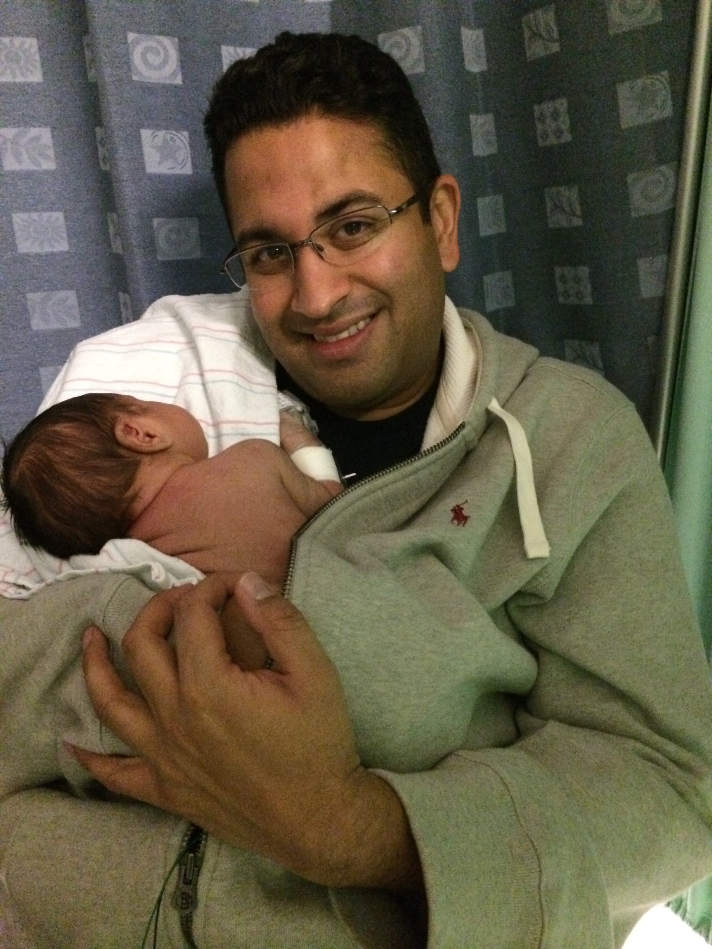 Dr. Shah holding his newborn son