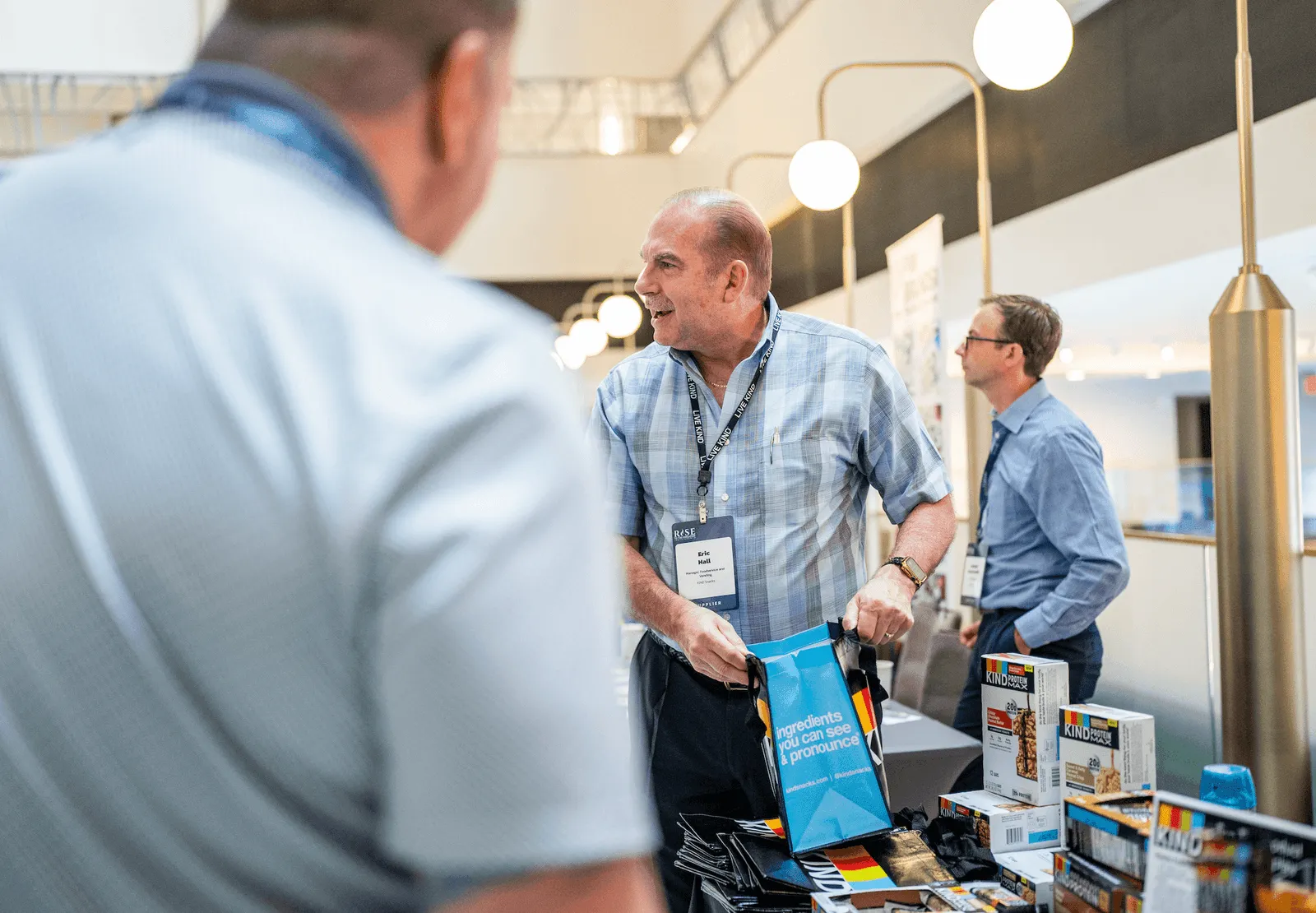 Participants of All Access event by Vistar North viewing industry participant booth