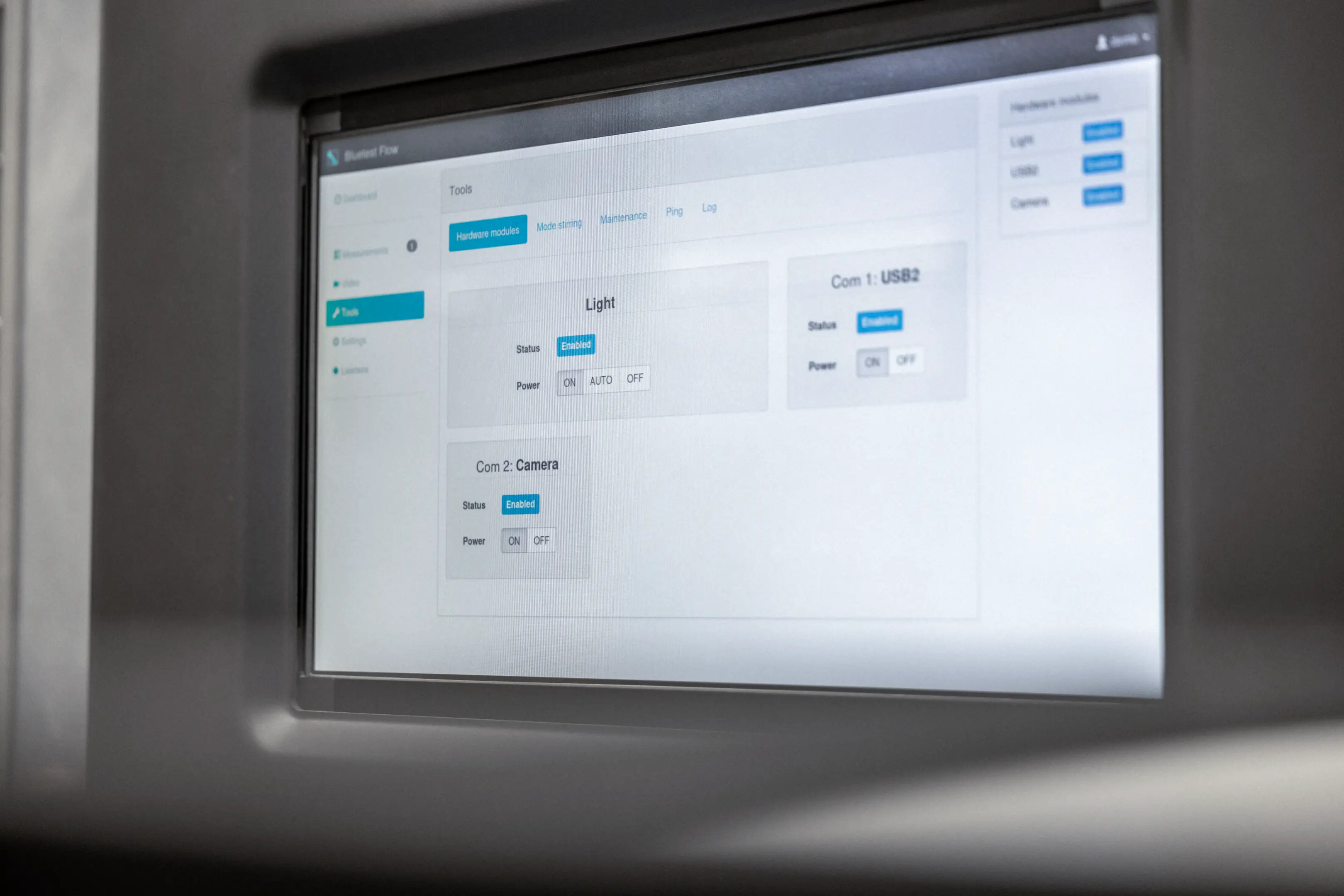 Close-up of a software interface screen showing hardware module settings for Light, USB2, and Camera with status enabled and power options.