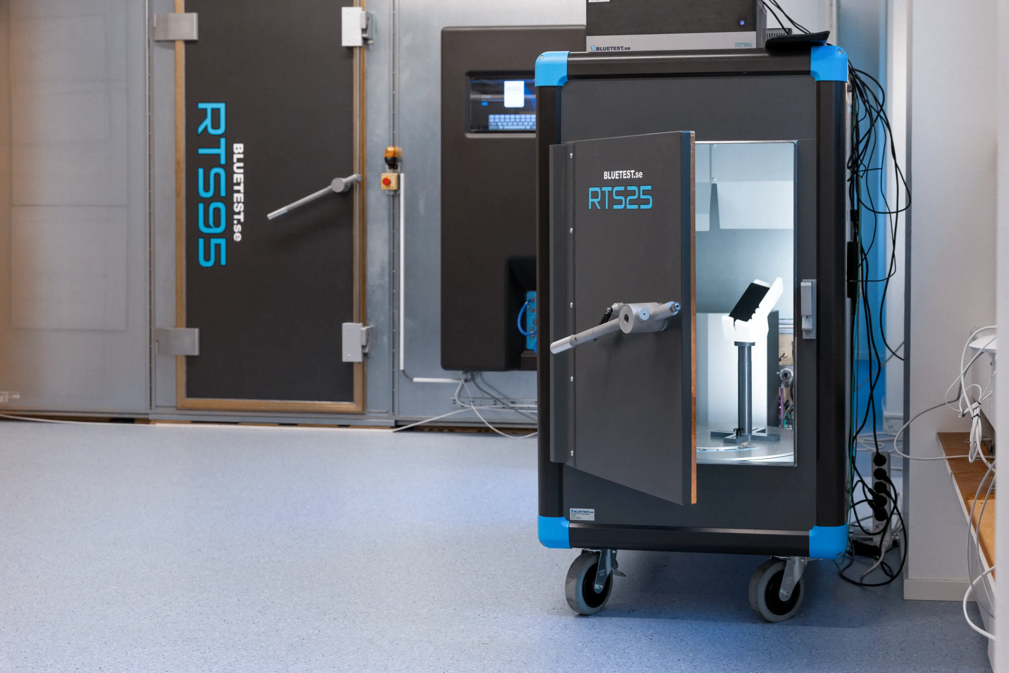 Two BLUETEST electromagnetic shielded test chambers labeled RTS25 and RTS95 in a clean laboratory room.