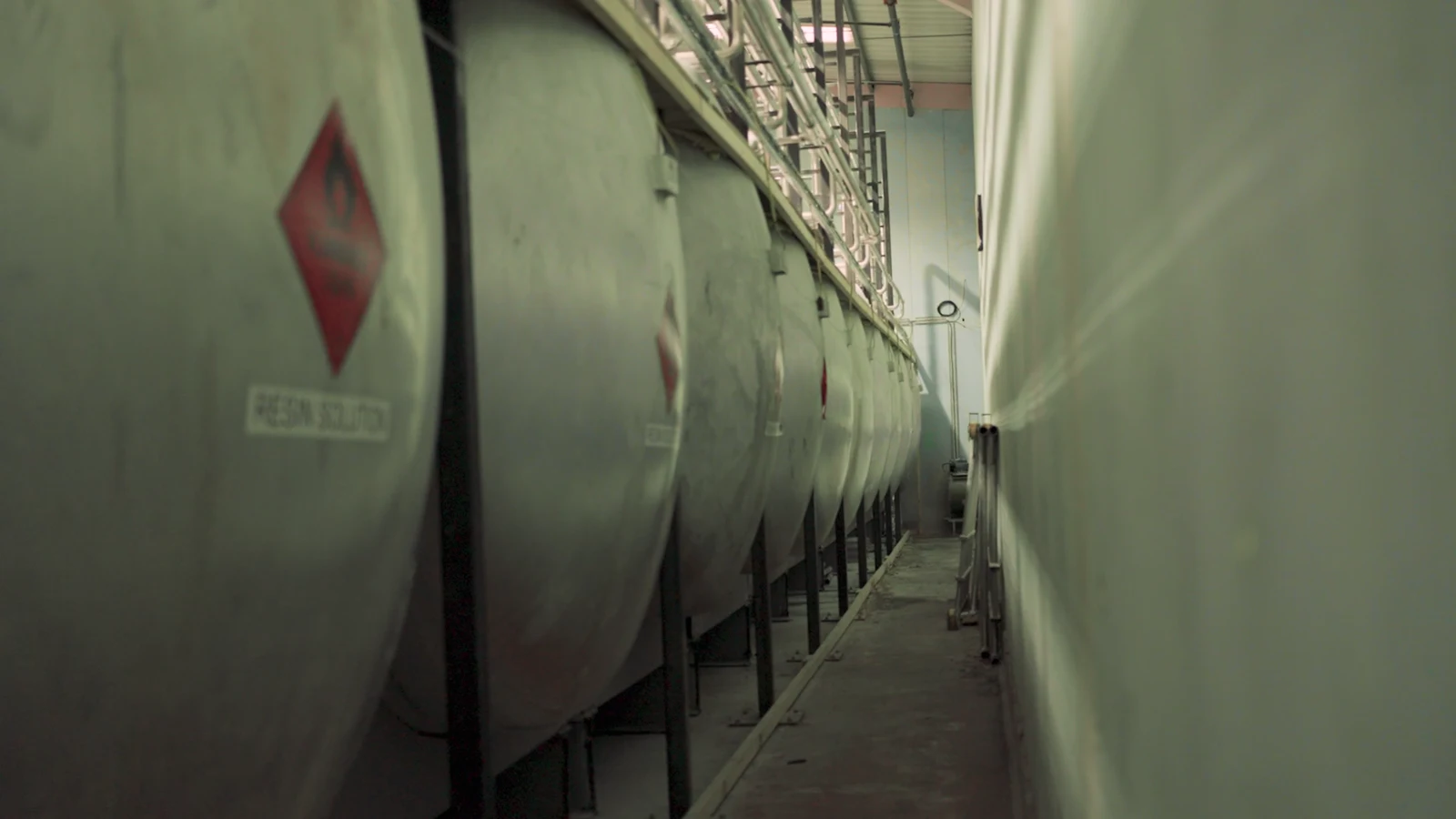 Row of bulk storage tanks in a chemicals manufacturing plant
