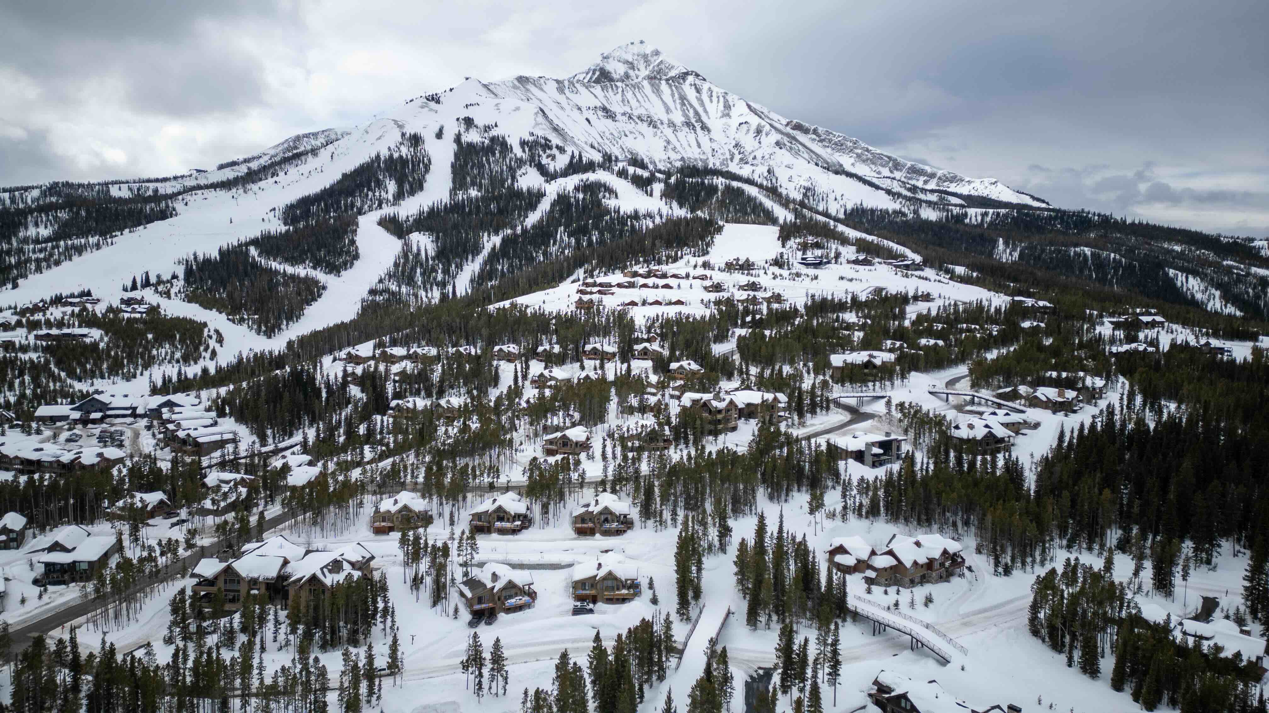 lone peak mountain with houses