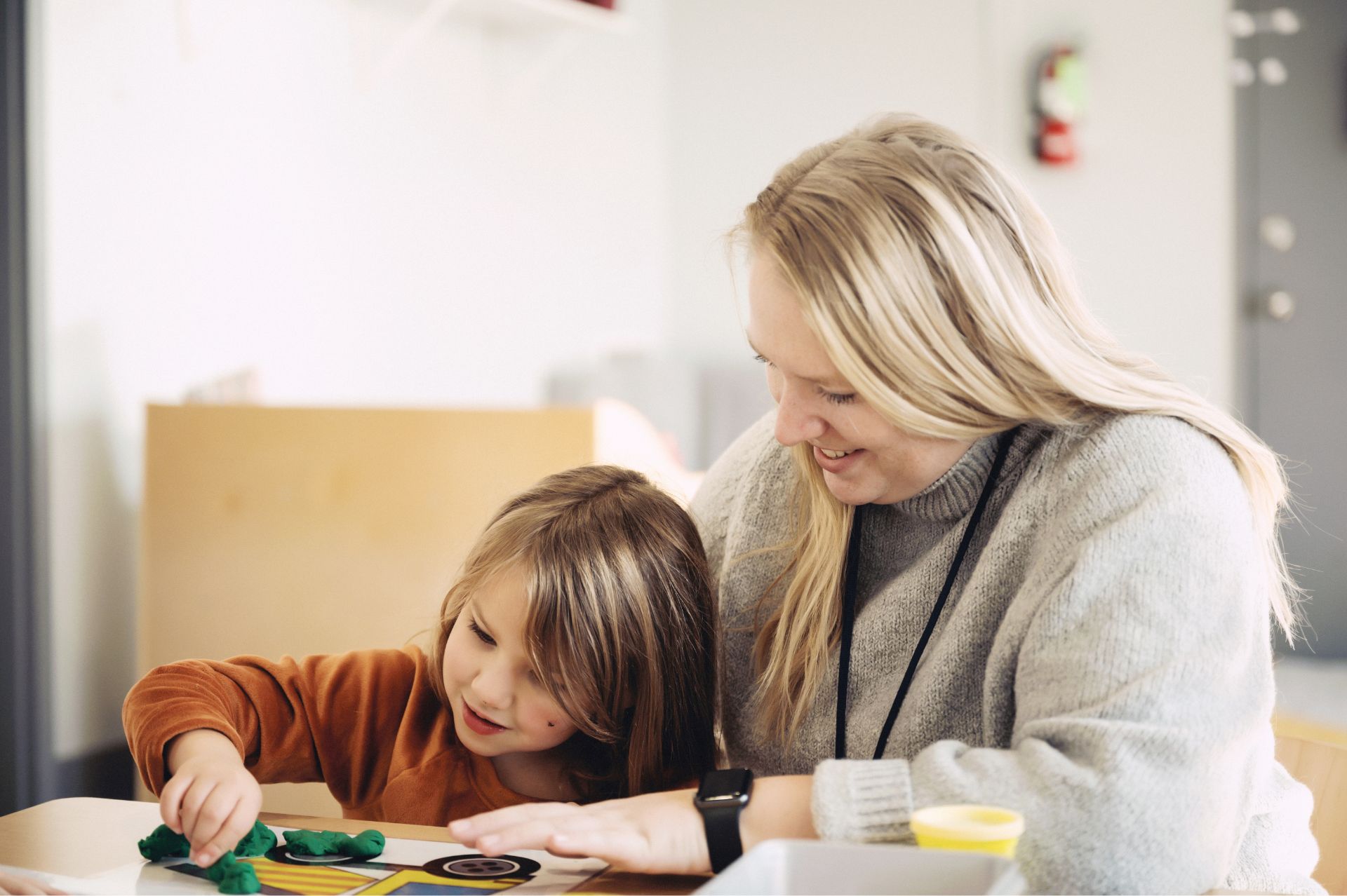 Amanda Zabel of Black Bear Academy smiling and talking to a young girl
