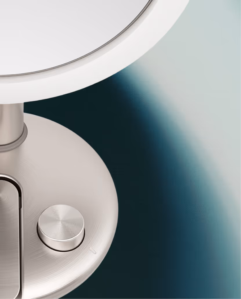 Close-up of a metallic dimmable LED ring light with a round control knob on its base.