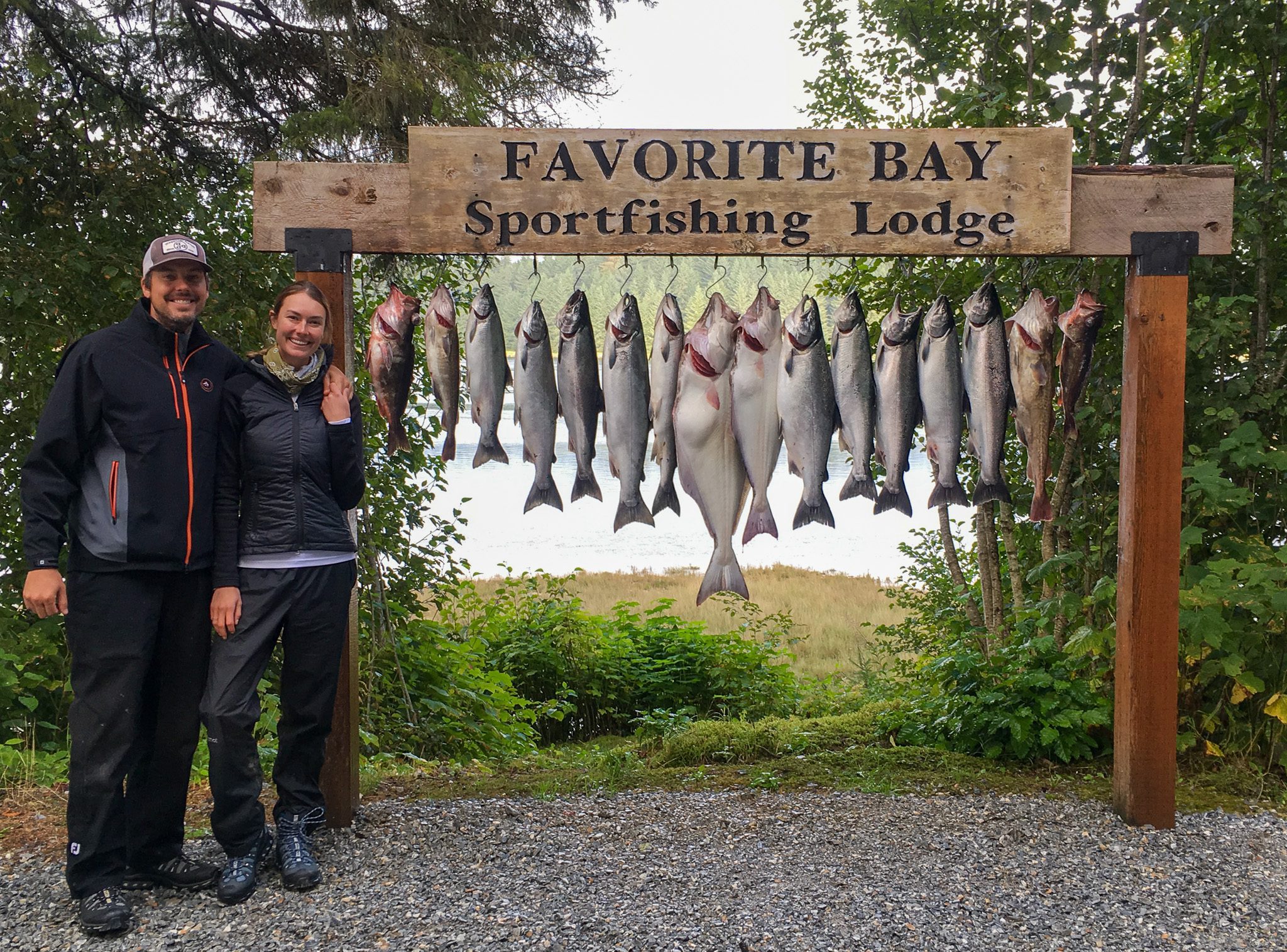 A picture of salmon hanging from the sign for Favorite Bay Lodge.