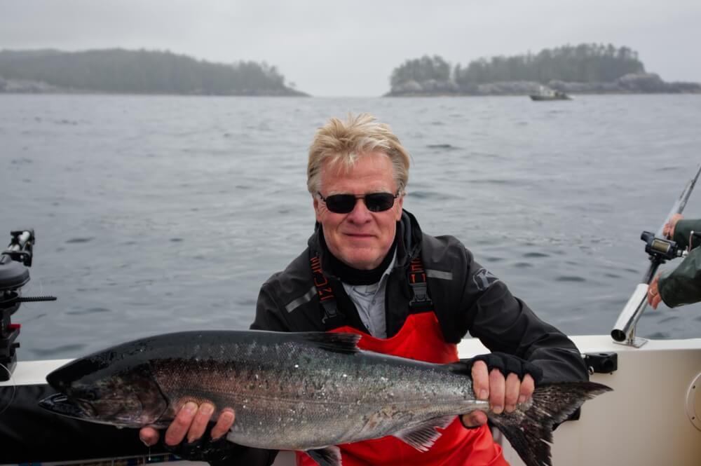 Alaska Fishing Lodge: An avid angler shows off his catch aboard an Alaska fishing charter.