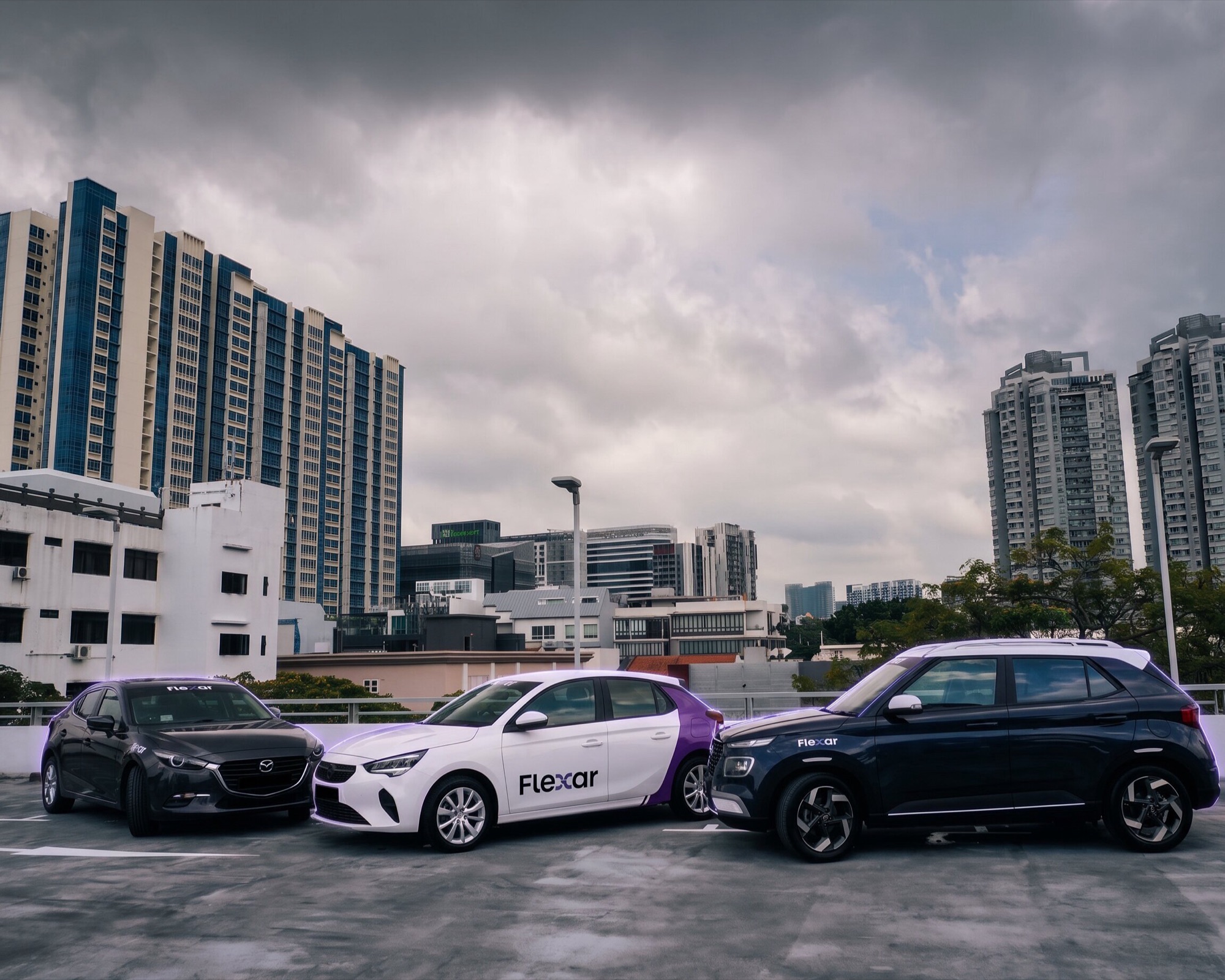 Three Flexar cars parked on a rooftop deck