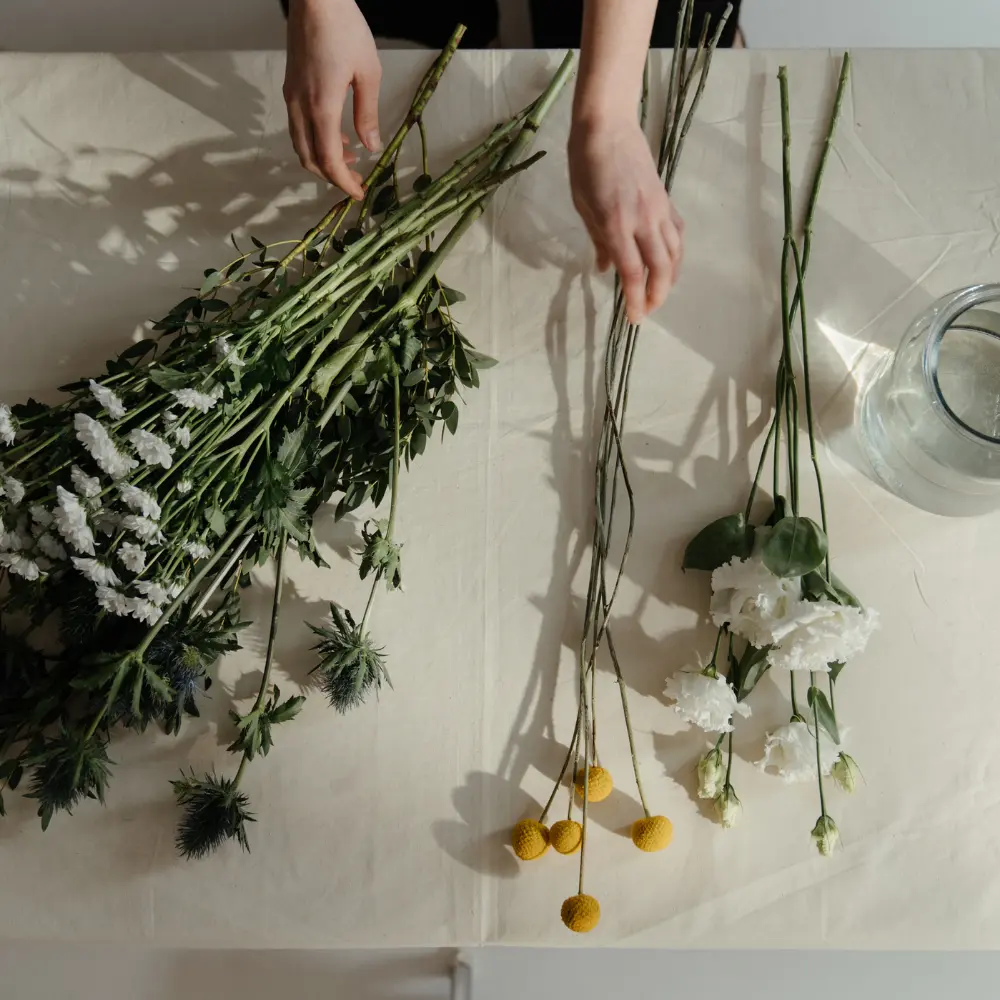 Preparation de bouquet avec tiges de fleurs fraiches en cours de coupe pour un fleuriste a Geneve avec livraison de fleurs dans toute la Suisse