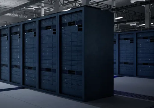 Rows of dark server racks with blinking indicator lights in a large, dimly lit data center.