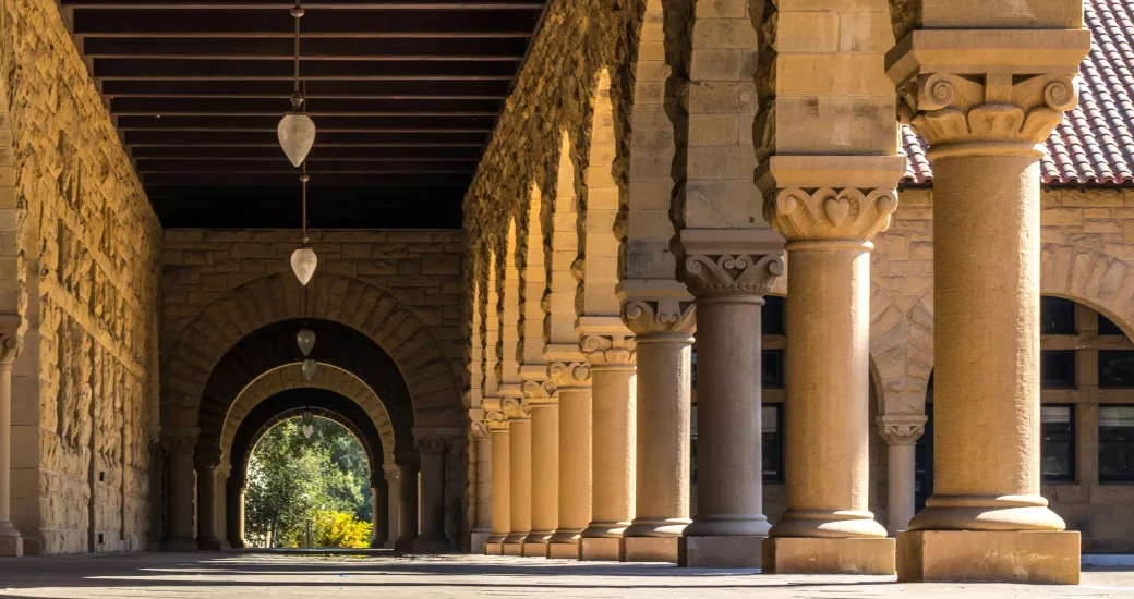 Historic Stanford University campus colonnade with arches, symbolizing academic excellence and innovation