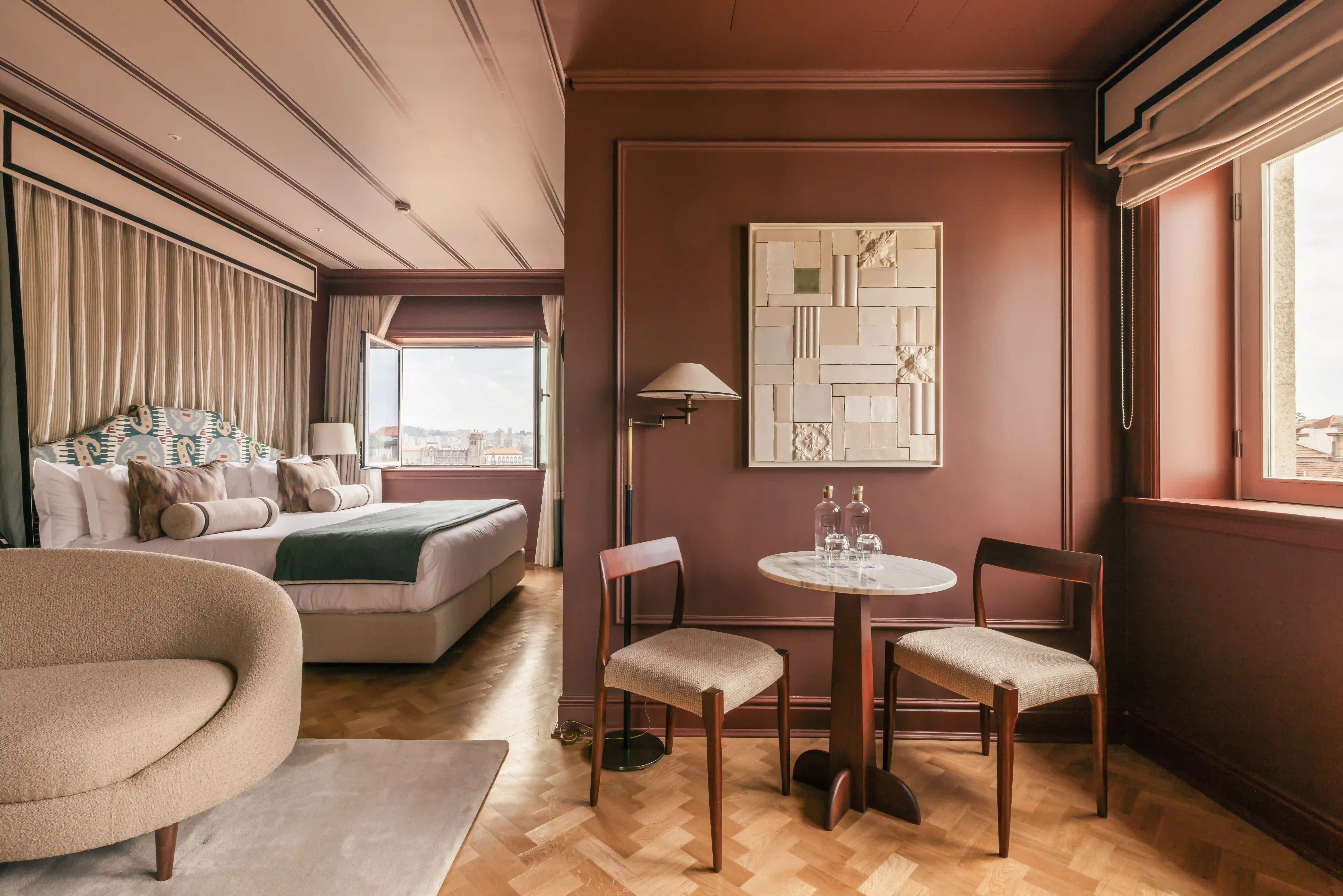 Elegant dining area and bedroom at Hotel Experimental Infante Sagres in Porto, featuring terracotta tones.