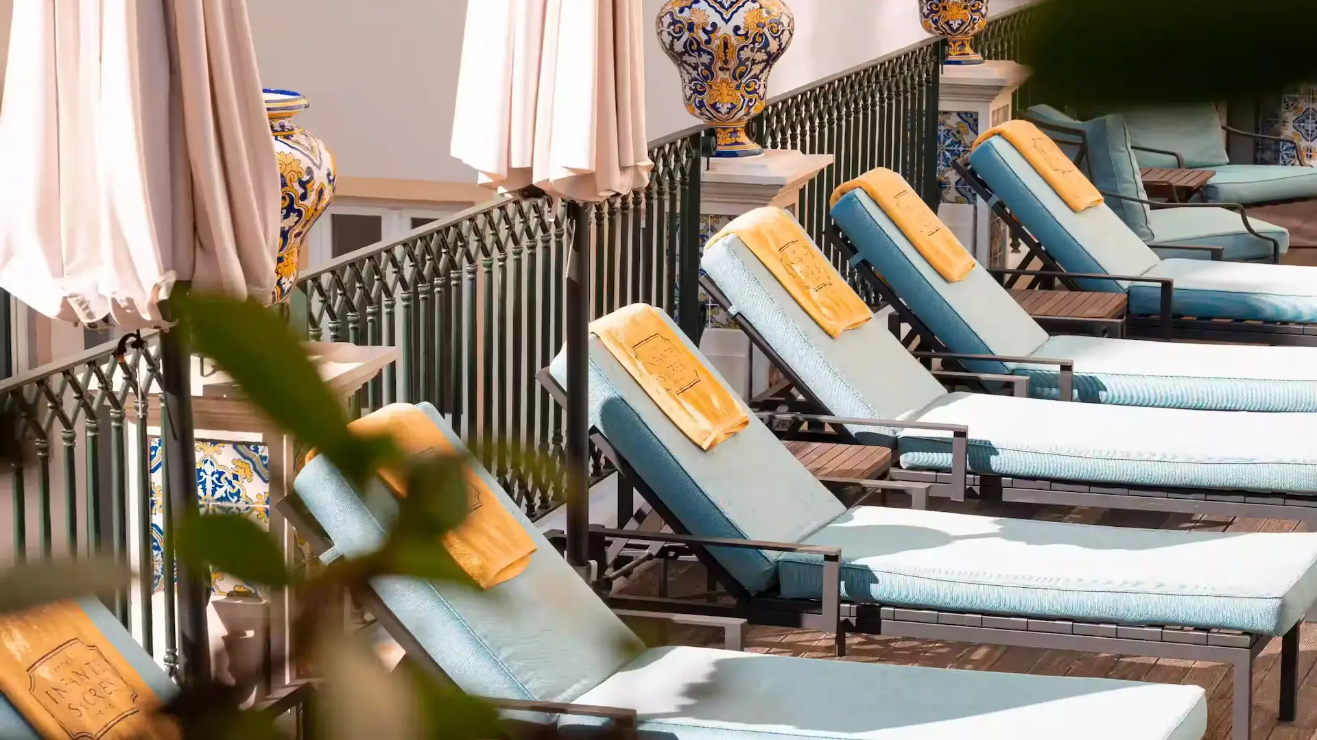 Sun loungers lined up on the sunny terrace of the Hotel Experimental Infante Sagres in Porto.