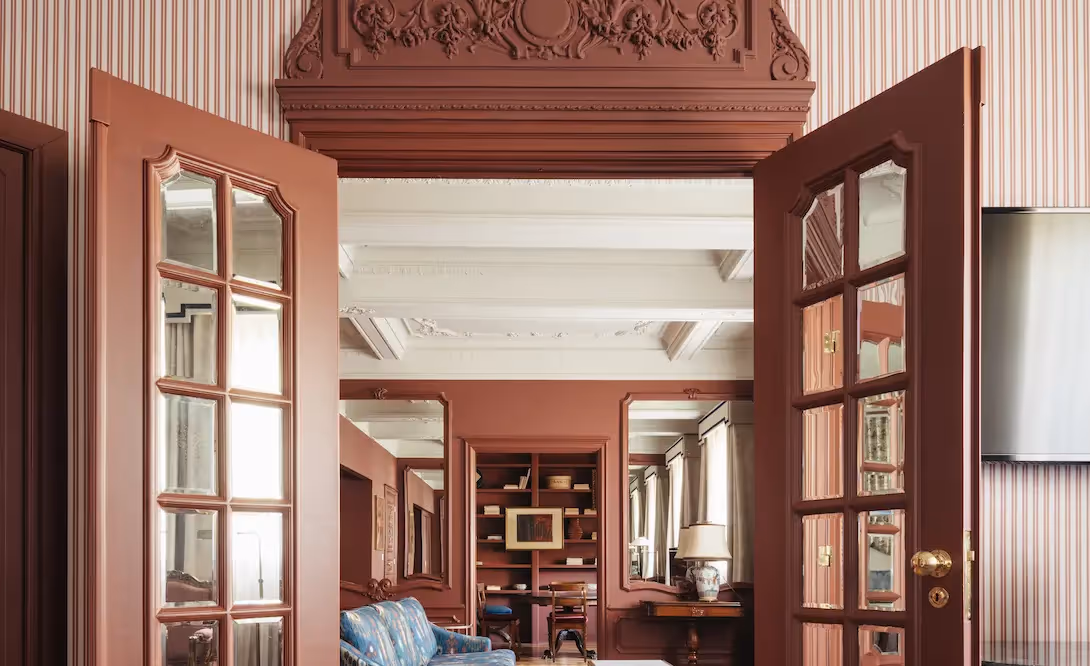 Large double doors slightly open revealing the refined interior architecture of Hotel Experimental Infante Sagres in Porto.