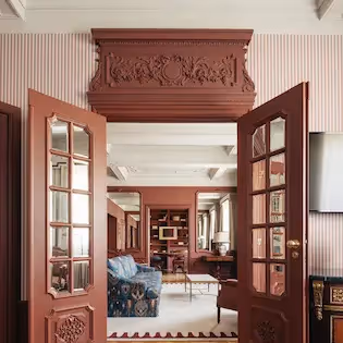 Large double doors slightly open revealing the refined interior architecture of Hotel Experimental Infante Sagres in Porto.