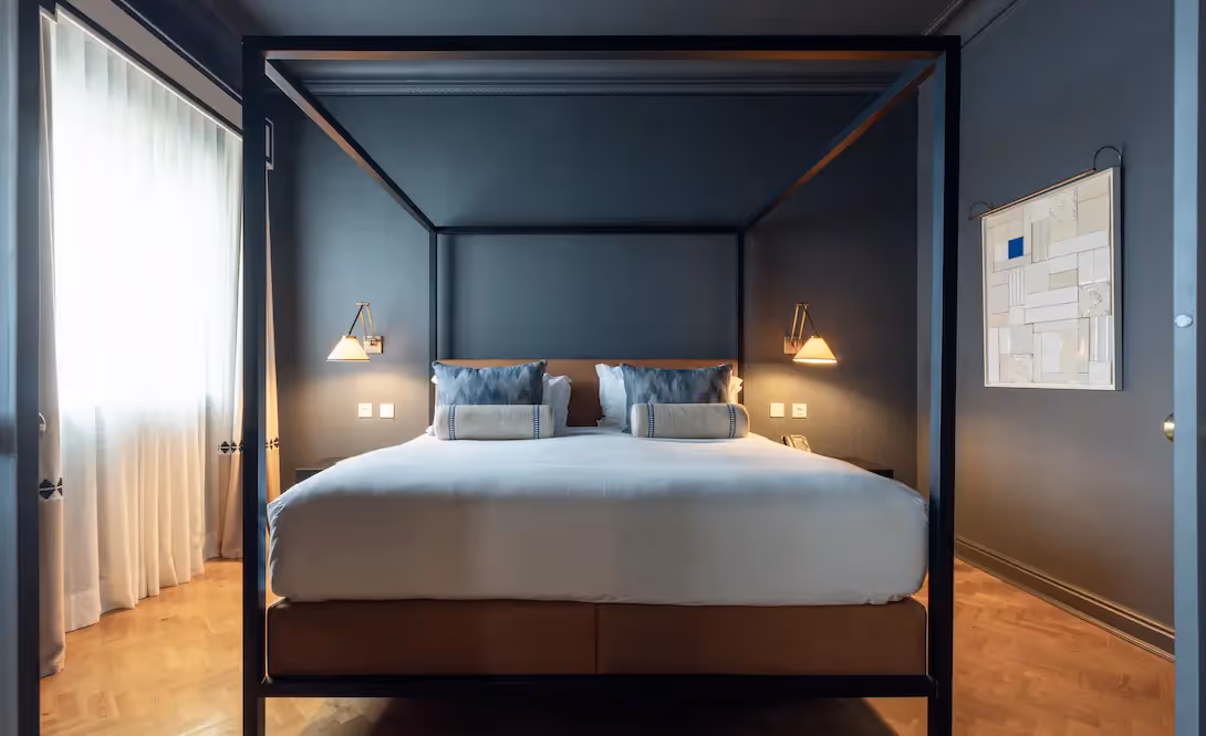 Elegant living room with striped wallpaper at Hotel Experimental Infante Sagres in Porto.